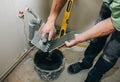 Maintenance repair works renovation in the flat. Restoration indoors in the flat. Man is priming a surface with a brush and palett Royalty Free Stock Photo