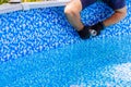 Maintenance service worker installs water filtration system, chlorination in a frame pool Royalty Free Stock Photo