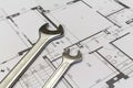 Wrench and project drawings with residential building Royalty Free Stock Photo