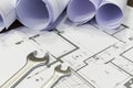 Wrench and project drawings with residential building Royalty Free Stock Photo