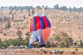 The maintenance team inflates the hot air balloon in the shape oThe maintenance team inflates the hot air balloon in the shape of