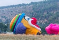 The maintenance team inflates the hot air balloon in the shape oThe maintenance team inflates the hot air balloon in the shape of