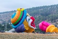 The maintenance team inflates the hot air balloon in the shape oThe maintenance team inflates the hot air balloon in the shape of