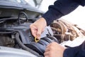 The maintenance technician is checking the condition of the engine to be ready for use. In the car service center Royalty Free Stock Photo