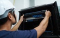 A maintenance technician works in a server room with a fiber optic hub Royalty Free Stock Photo