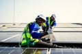 Maintenance technicians installing solar panels at solar cell farm Royalty Free Stock Photo