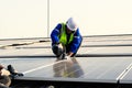 Maintenance technicians installing solar panels at solar cell farm Royalty Free Stock Photo