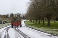 A maintenance tractor carrying wood debris to be composted at the local cemetary in Bangor county down Northern ireland