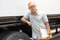 Maintenance and Vehicle safety inspection. Asian a truck driver holding clipboard standing with trailer truck. Royalty Free Stock Photo