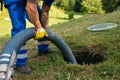 Maintenance Worker emptying household septic tank Royalty Free Stock Photo