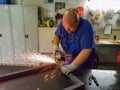 Maintenance worker with grinding machine, industrial job, electric equipment Royalty Free Stock Photo