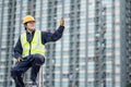 Maintenance worker showing thumb up on ladder Royalty Free Stock Photo