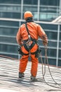 maintenance worker using a fall arrest system while repairing a roof Royalty Free Stock Photo