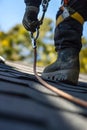 maintenance worker using a fall arrest system while repairing a roof Royalty Free Stock Photo