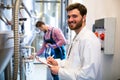 Maintenance workers examining brewery machine Royalty Free Stock Photo