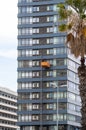 Maintenance workers on a hanging cradle or lifting platform carrying out repair work on the facade of a modern multi-storey office Royalty Free Stock Photo