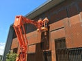 Maintenance Workers on Orange Cherry Picker Crane