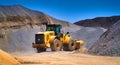 Maintenance of yellow excavator on a construction site against blue sky Royalty Free Stock Photo