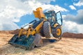 Maintenance of yellow excavator on a construction site against blue sky. repearing wheel loader at sandpit during earthmoving