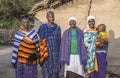 Maasai family in theior best clothing outside thier home