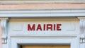 `Mairie` sign ie `Town hall` in French written in red, over the door of a french town hall Royalty Free Stock Photo