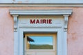 `Mairie` sign ie `Town hall` in French written in red, over the door of a french town hall Royalty Free Stock Photo