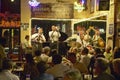 Maison Bourbon Jazz Club with Dixieland band and trumpet player performing at night in French Quarter in New Orleans, Louisiana