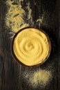 Maize flour in a bowl on wooden background. Top view Royalty Free Stock Photo