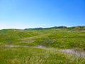 a majestic aerial shot of the lush green hillsides and mountains with a long winding road