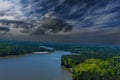 A majestic aerial shot of a rippling lake surrounded by vast miles of lush green trees with a beach on the banks of the lake Royalty Free Stock Photo