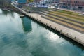 A majestic aerial shot of a still green waters of the Cumberland River with a view of the grassy staircases on the shore