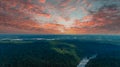 A majestic aerial shot of vast miles of lush green trees with the Chattahoochee river running through them with powerful clouds