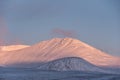 Majestic Alpen Glow hitting mountain peaks in Scottish Highlands during stunning Winter landscape sunrise Royalty Free Stock Photo