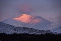 Majestic Alpen Glow hitting mountain peaks in Scottish Highlands during stunning Winter landscape sunrise Royalty Free Stock Photo