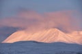 Majestic Alpen Glow hitting mountain peaks in Scottish Highlands during stunning Winter landscape sunrise Royalty Free Stock Photo