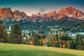 Majestic alpine cityscape with high mountains at sunset, Dolomites, Italy