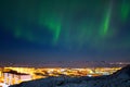 Majestic arctic landscape with aurora borealis over the northern city of Anadyr Royalty Free Stock Photo