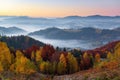 Majestic autumn rural scenery. Landscape with beautiful mountains, fields and forests covered with morning fog. Royalty Free Stock Photo