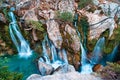 Majestic Big waterfall cascading down a rugged cliff in Kourtaliotiko Gorge, Foinikas, Crete, Greece Royalty Free Stock Photo