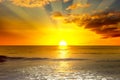 Majestic bright sunrise over ocean and light waves