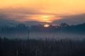 Majestic bright sunset cloudscape over a foggy field