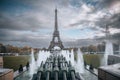 a statue of a man holding a horse with the eiffel tower in the