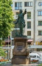 Majestic bronze statue of Russian emperor Peter I on pedestal of pink Pavlovsk granite at Petrovsky Square.