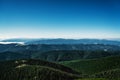 Majestic Carpathian mountains range. A view of the forested slopes of the mountains with evergreen conifers. Sunny day with blue Royalty Free Stock Photo