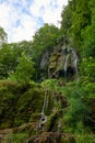 Majestic Cascade: Uracher Wasserfall Amidst Verdant Forest Landscape. Tranquil Retreat: Uracher Wasserfall -