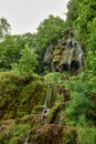 Majestic Cascade: Uracher Wasserfall Amidst Verdant Forest Landscape. Tranquil Retreat: Uracher Wasserfall -