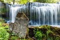 Majestic, cascading waterfall streaming down a rocky cliff in the midst of a lush, verdant forest Royalty Free Stock Photo