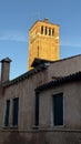 a tall clock tower towering over a brick building with lots of windows. Venice Italy Royalty Free Stock Photo