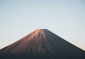 The peak is dusted with light, enhancing its volcanic features Royalty Free Stock Photo