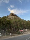 Majestic Crown-Shaped Rock Formation Rising Above the Lush Treetops in the Heart of the Forest. Royalty Free Stock Photo